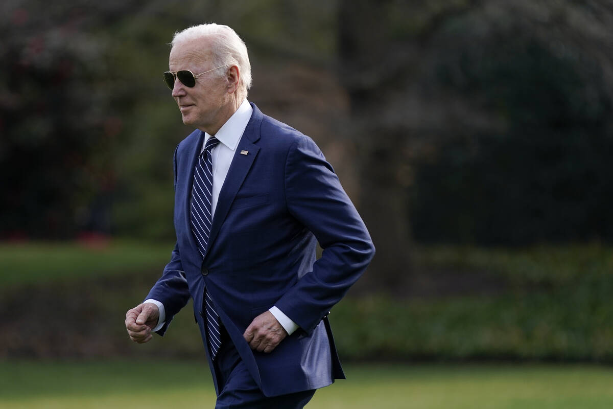 President Joe Biden jogs across the South Lawn of the White House to speak with visitors before ...