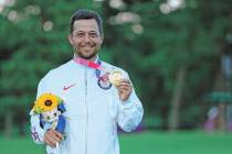 Xander Schauffele, of the United States, holds his gold medal in the men's golf at the 2020 Sum ...