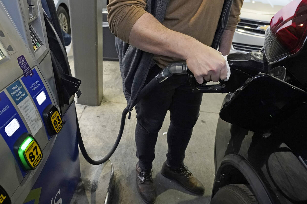 A customer pumps gasoline into his car at a Sam's Club fuel island in Gulfport, Miss., Feb. 19, ...