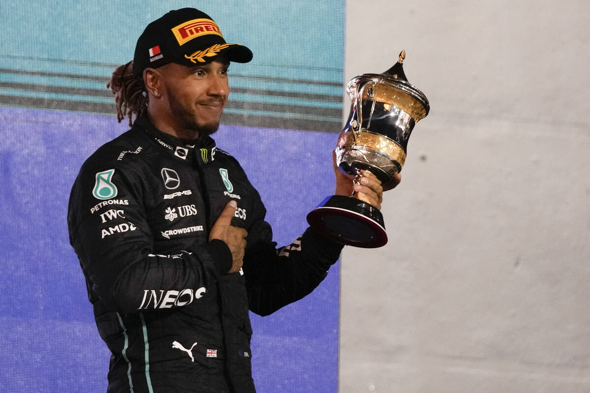 Third placed Mercedes driver Lewis Hamilton of Britain stands on the podium after the Formula O ...