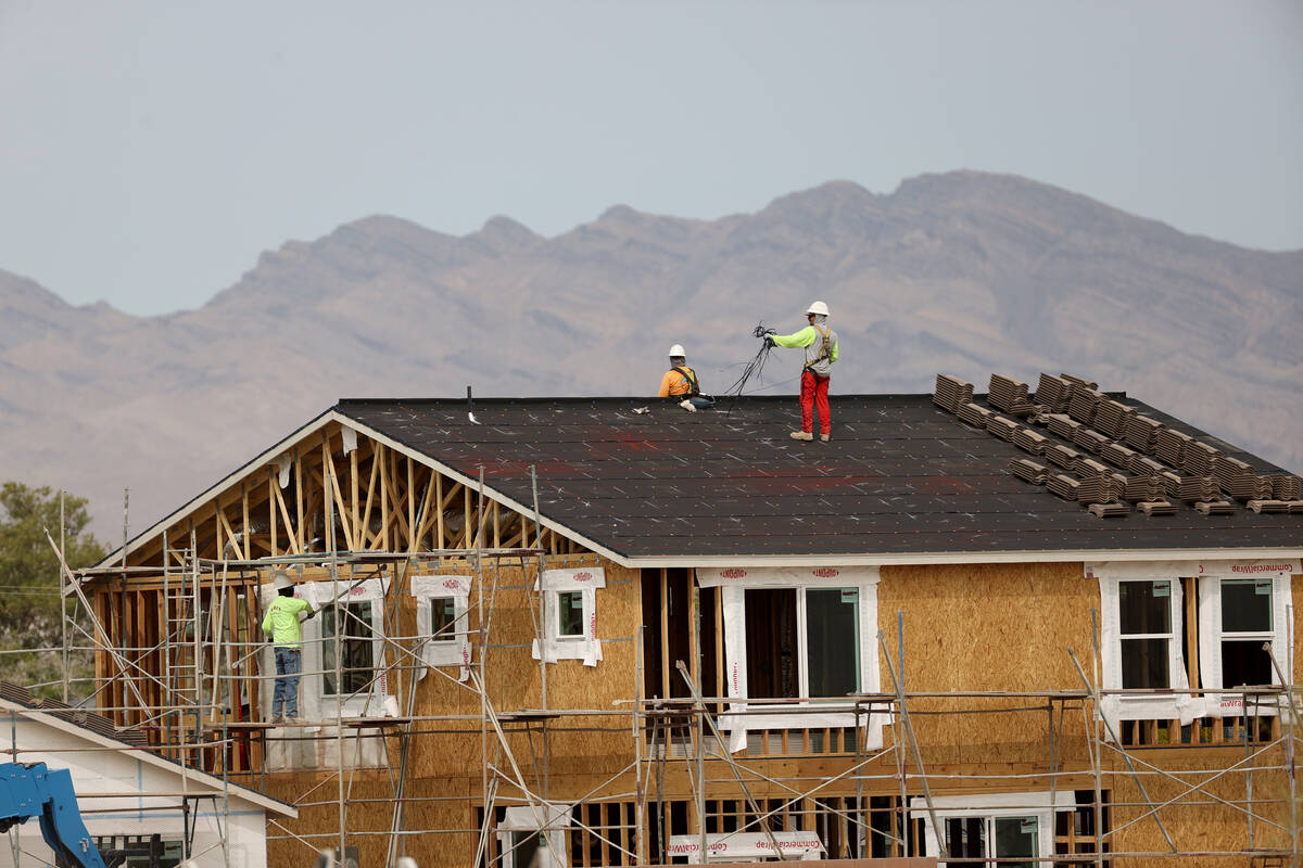 Workers on the roof of a home under construction in the Beazer Homes community in Indian Spring ...