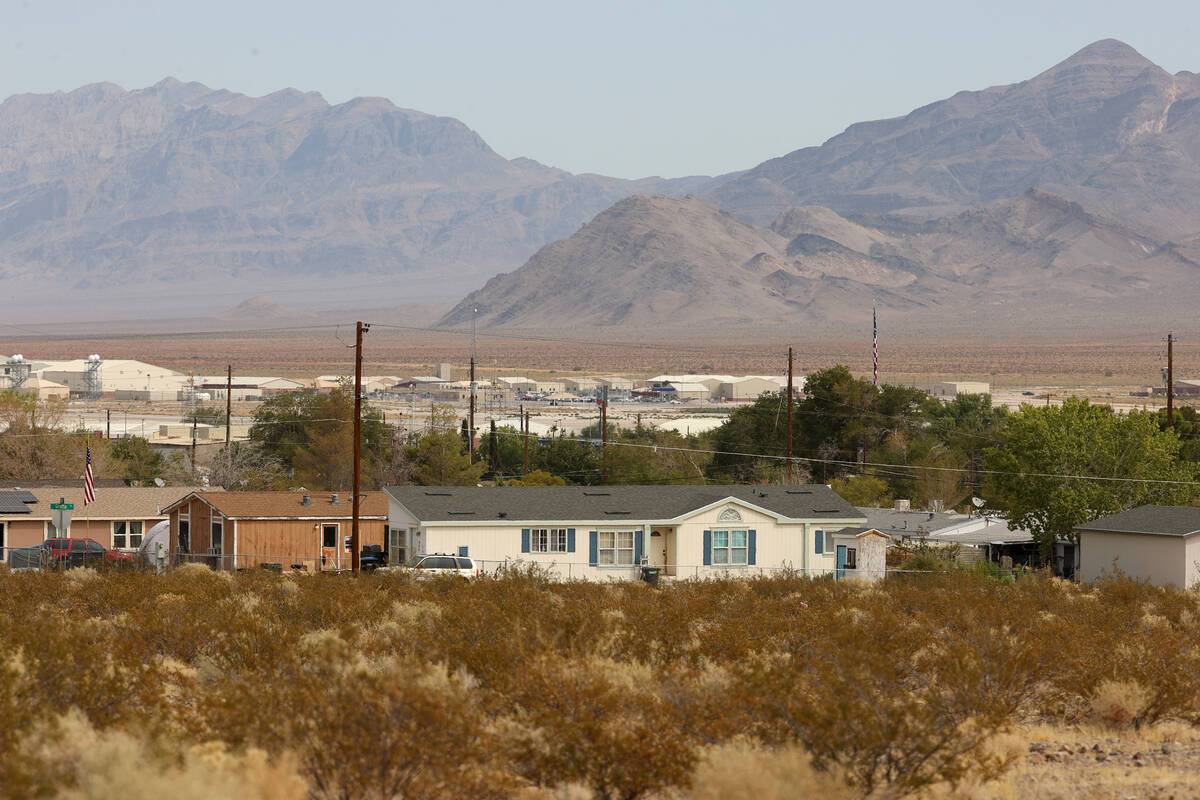 Creech Air Force Base is seen in the distance behind mobile homes at Indian Springs, Friday, Se ...