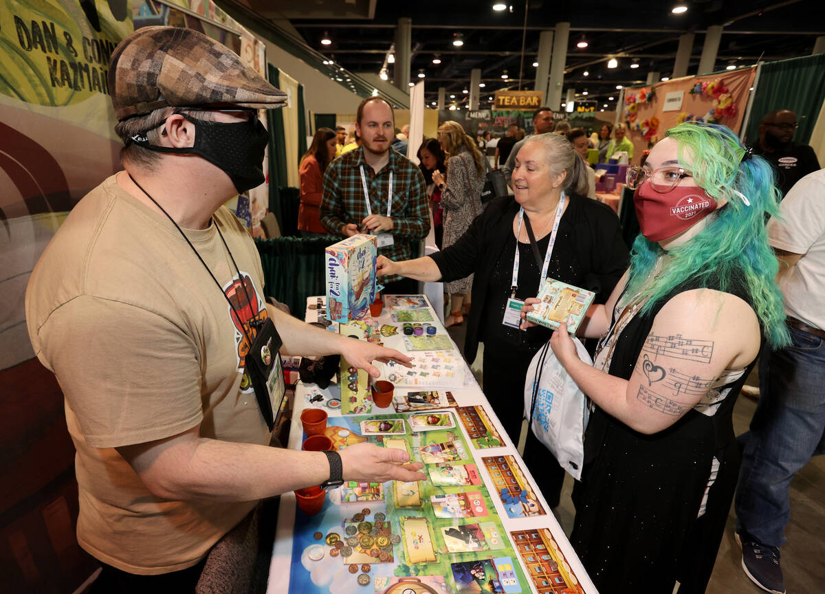 Dave Chapman, left, and Dan Kazmaier of Steeped Games show April Bricker, right, and Darlene St ...