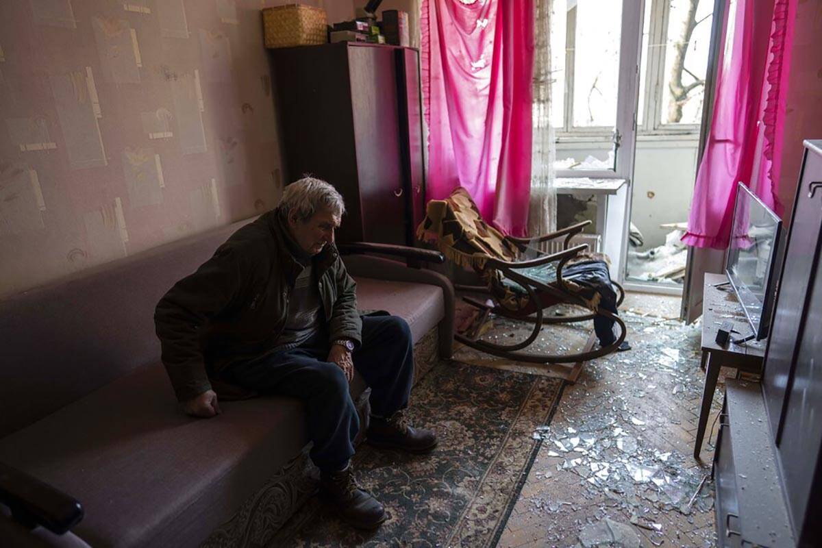 Volodymyr, 80, rests inside his apartment damaged by shelling, in Kyiv, Ukraine,Wednesday, Marc ...