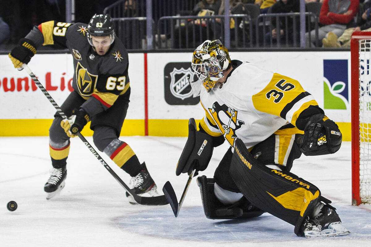Golden Knights right wing Evgenii Dadonov (63) shoots on Pittsburgh Penguins goaltender Tristan ...