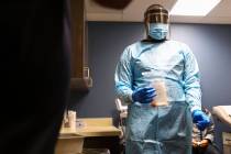 In this Dec. 2, 2021, file photo, UMC charge nurse Terron Gregory prepares to store the sample ...