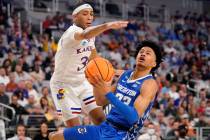 Kansas guard Dajuan Harris Jr. defends as Creighton guard Trey Alexander (23) attempts a shot i ...