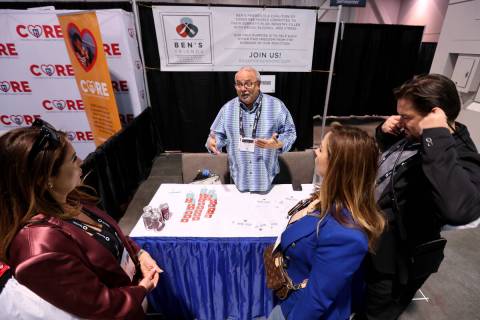 Mickey Bakst, co-founder at Ben’s Friends, talks to, from left, Iris Male, Alba Male and ...