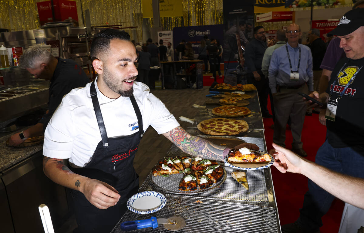 Chef Daniele Gagliotta hands out pizza at the Marra Forni Brick Oven Cooking Solutions booth du ...