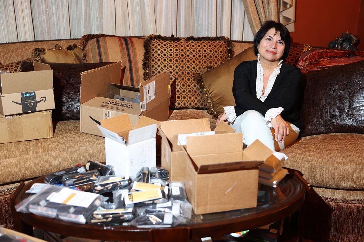 Alona Burns poses for a portrait with hundreds of donated tourniquets at her Las Vegas home Fri ...