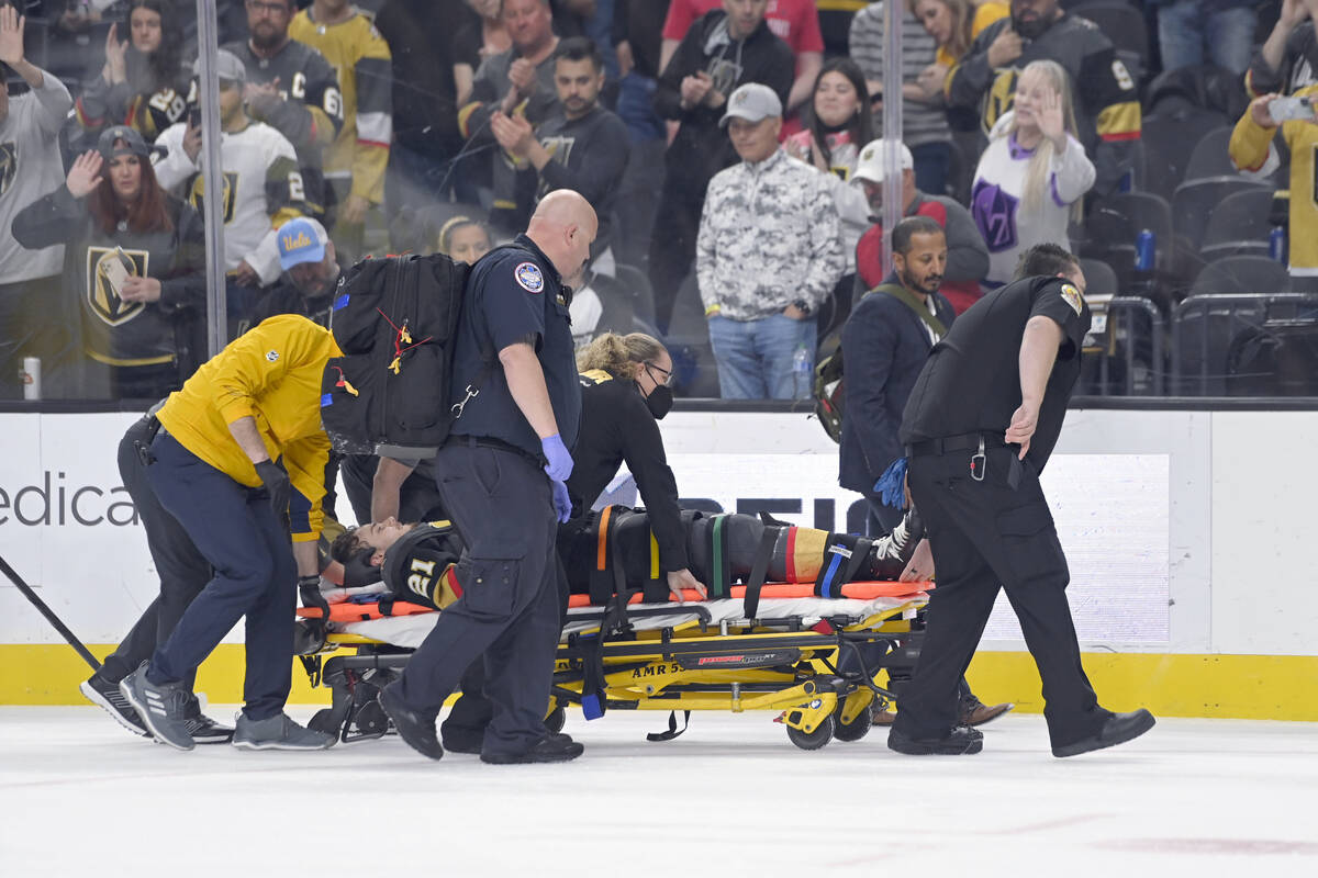 Vegas Golden Knights center Brett Howden is carried off the ice after an injury during the firs ...