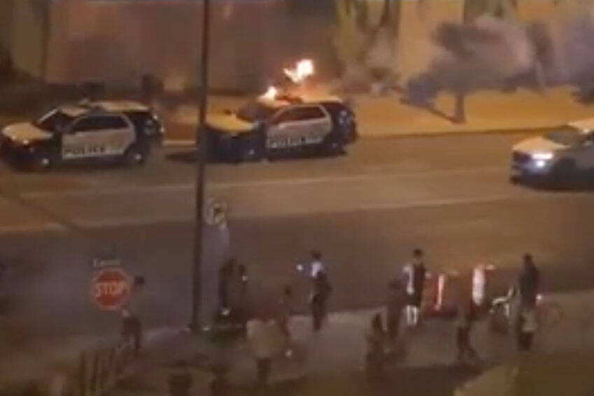 This screenshot shows a police car on fire during a protest in Las Vegas in May 2020. (Rio Lac ...
