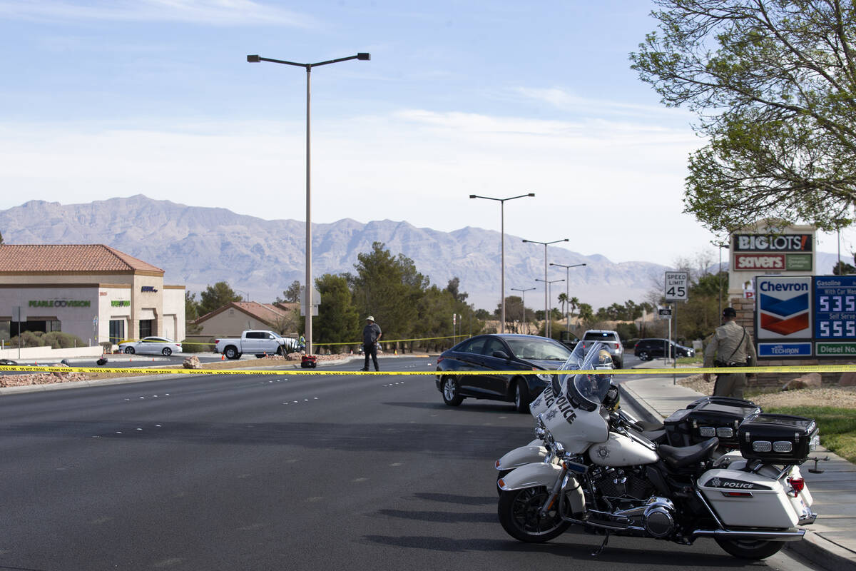 Las Vegas police attend to the scene where a motorcyclist died in a crash at the intersection o ...