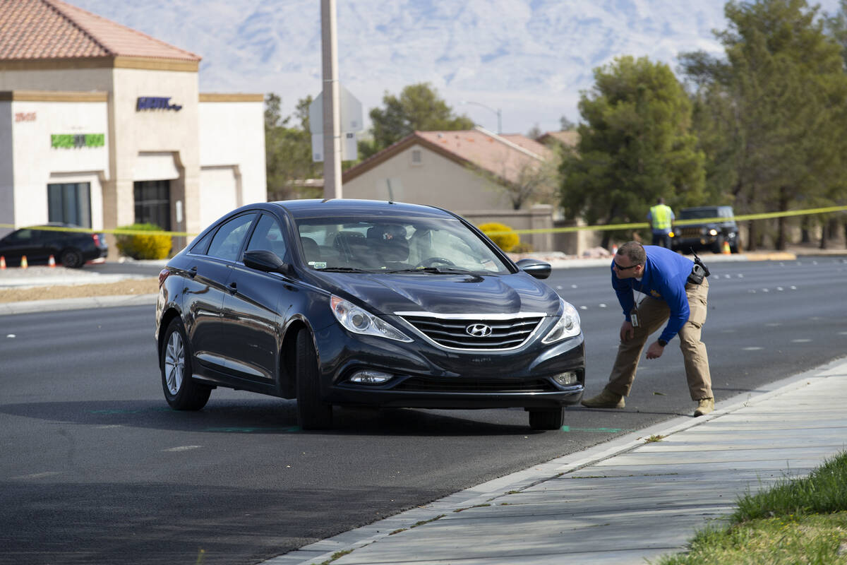 Las Vegas police attend to the scene where a motorcyclist died in a crash at the intersection o ...