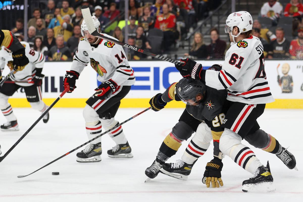 Vegas Golden Knights left wing William Carrier (28) battles for the puck against Chicago Blackh ...