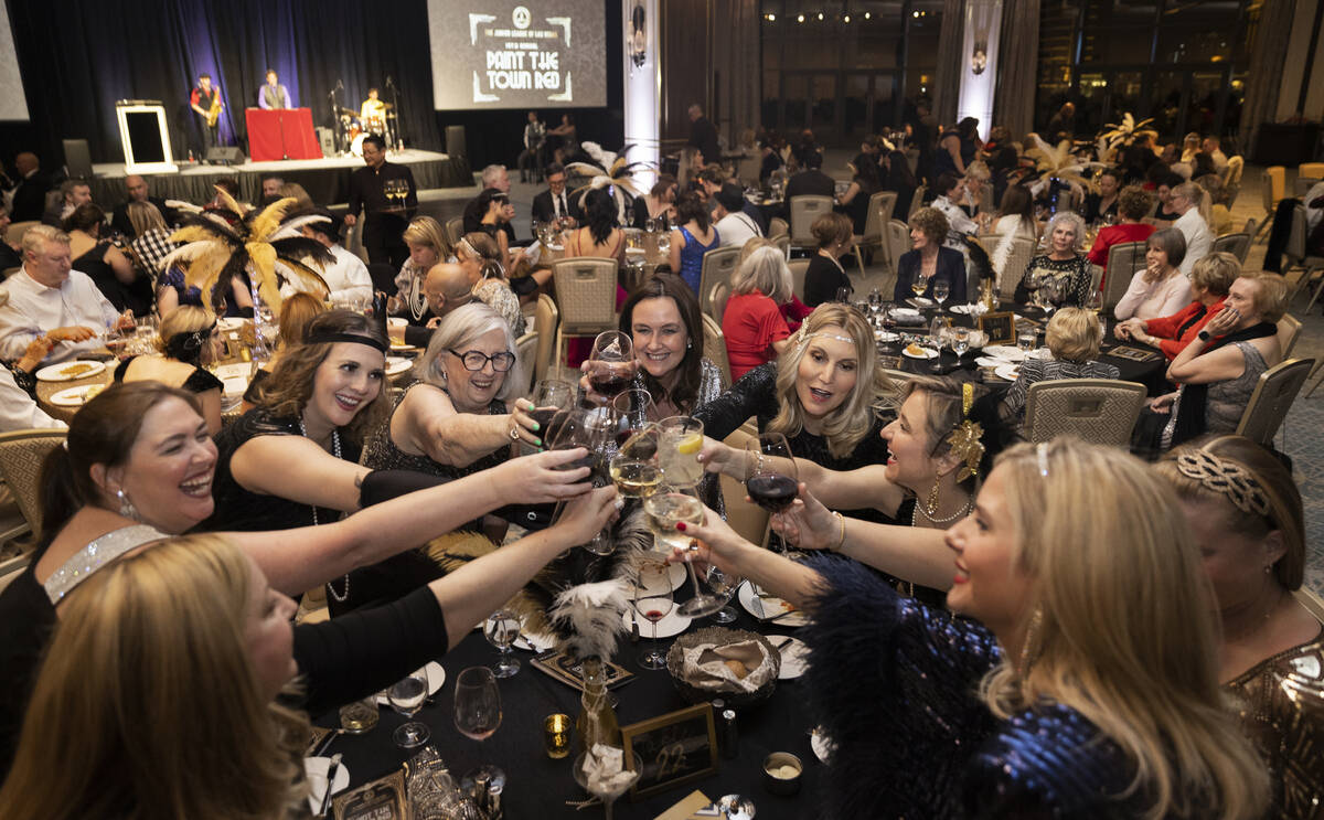 Guests celebrate during dinner at the 19th annual Junior League of Las Vegas “Paint The Town ...