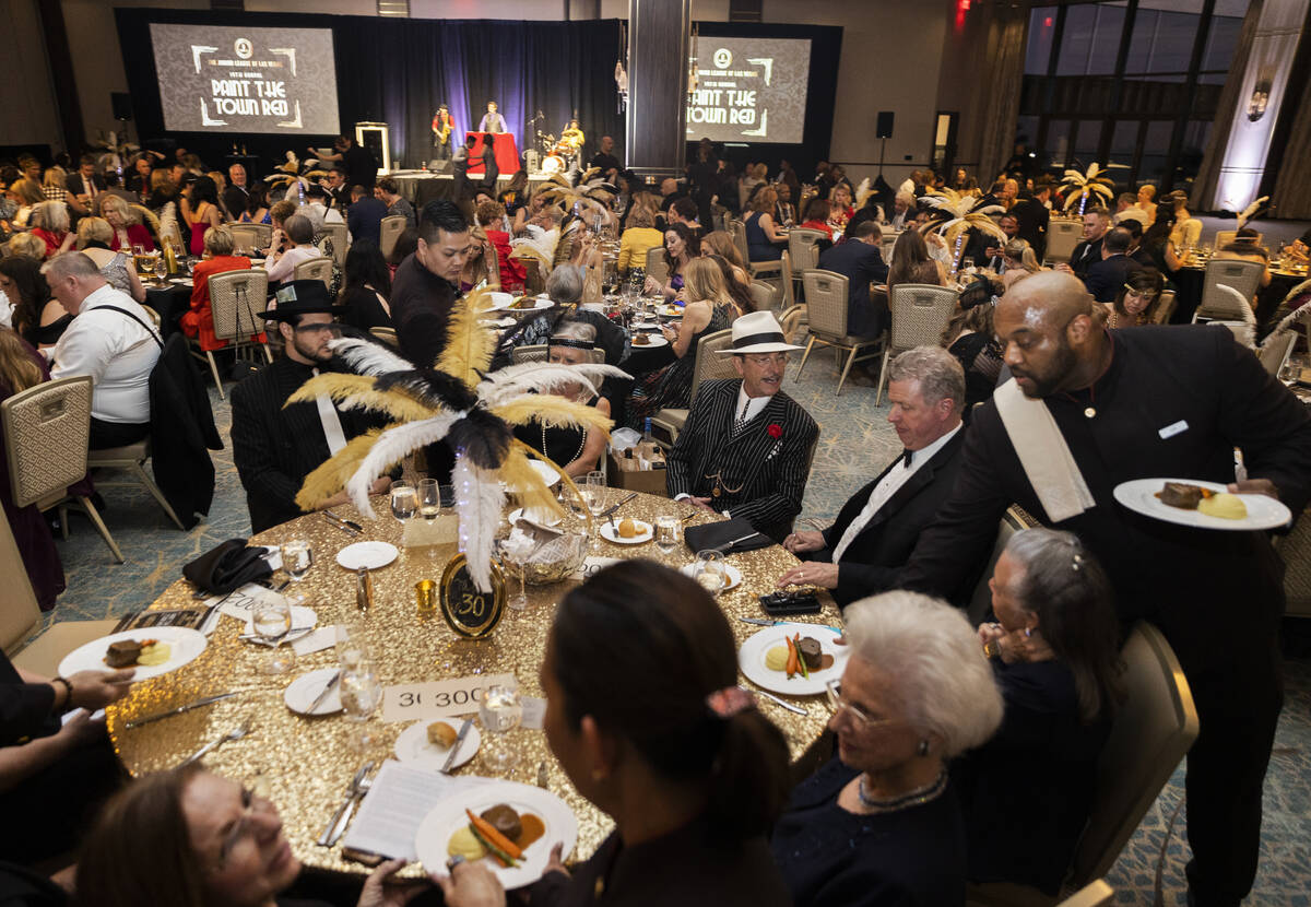 Guests are served dinner during the 19th annual Junior League of Las Vegas “Paint The Town Re ...