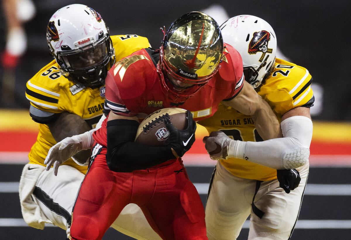 Vegas Knight Hawks running back Elad Covaliu (25) carries Tucson Sugar Skulls defensive lineman ...