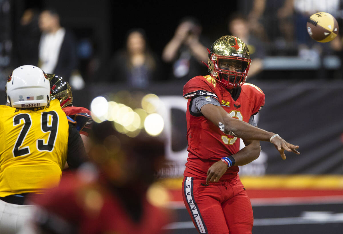 Vegas Knight Hawks quarterback Jaylon Henderson (9) gets the ball away with pressure from Tucso ...