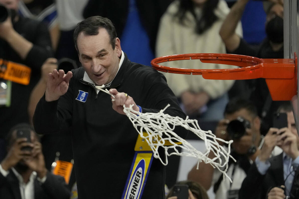 Duke head coach Mike Krzyzewski celebrates while cutting down the net after Duke defeated Arkan ...
