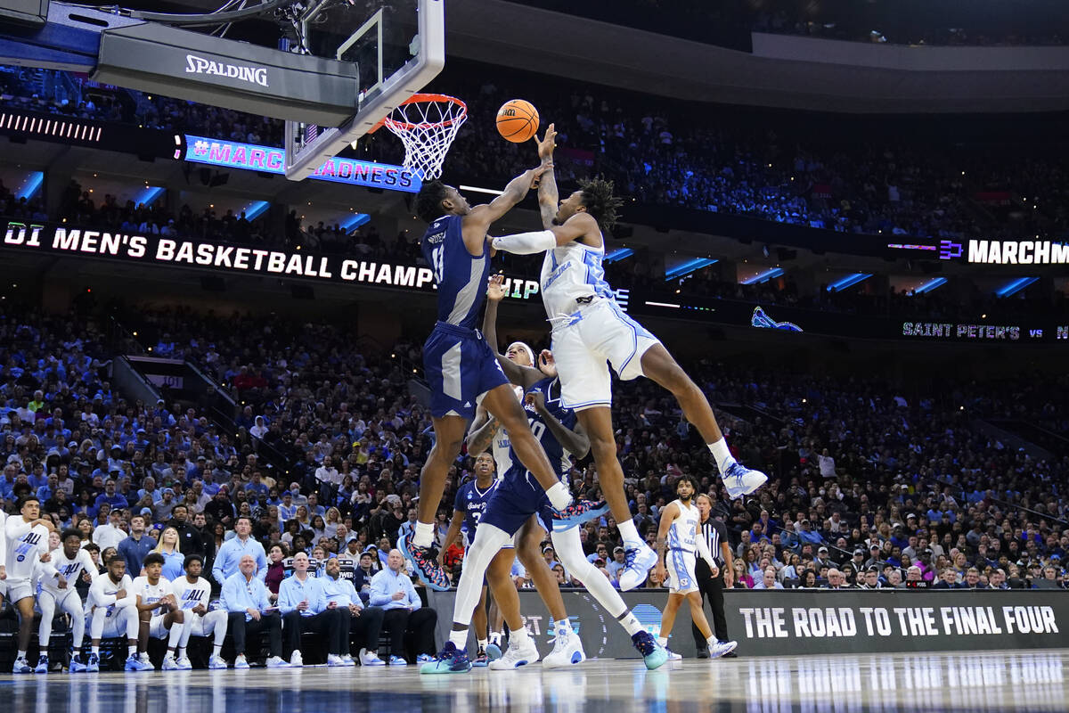 North Carolina's Leaky Black, right, goes up for a shot against St. Peter's Fousseyni Drame dur ...
