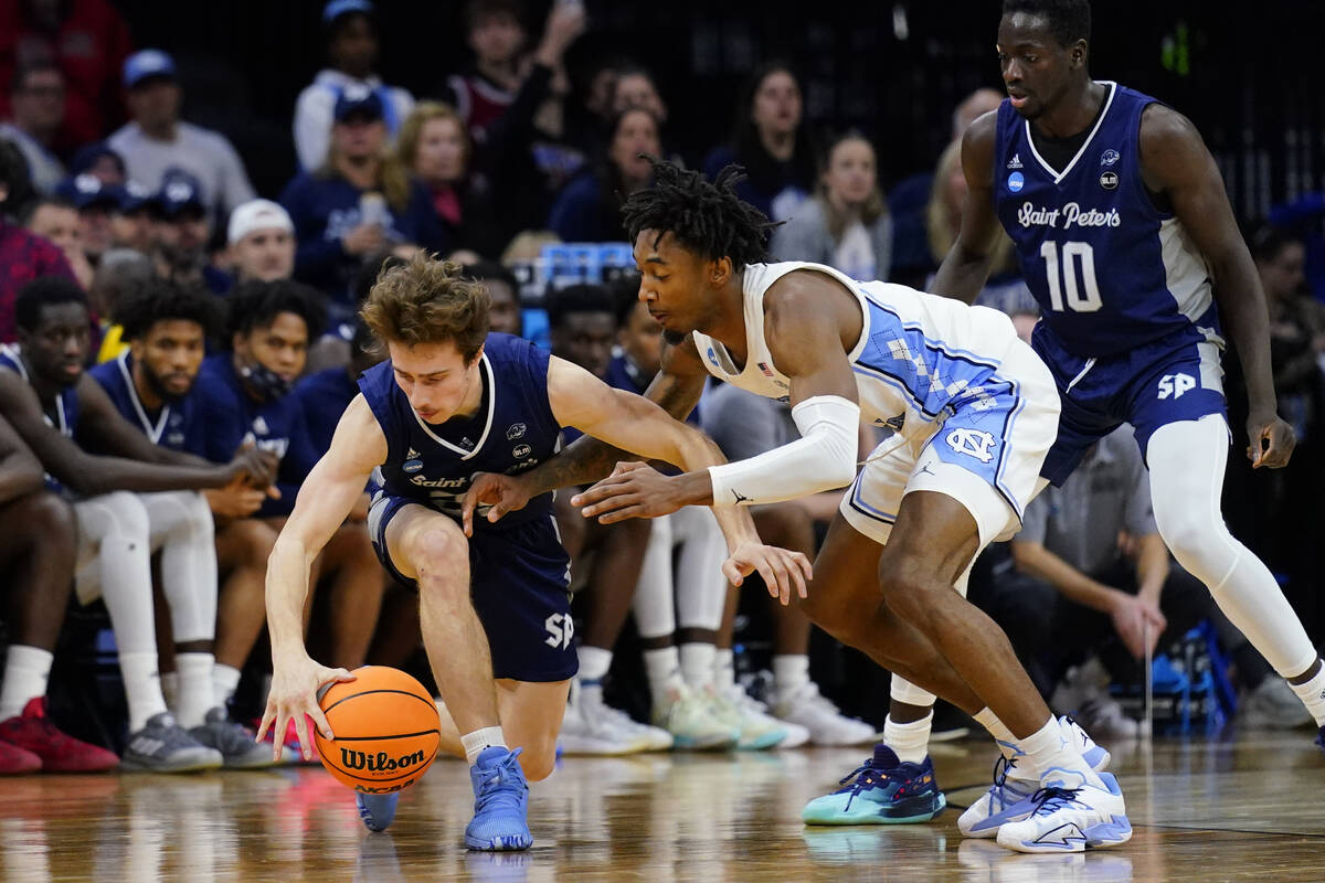 St. Peter's Doug Edert, left, and North Carolina's Leaky Black battle for a loose ball during t ...