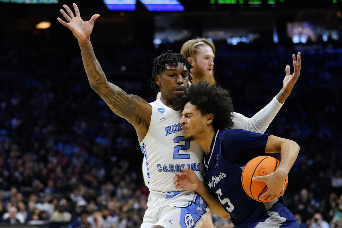 St. Peter's Daryl Banks III (5) tries to get past North Carolina's Caleb Love (2) during the fi ...