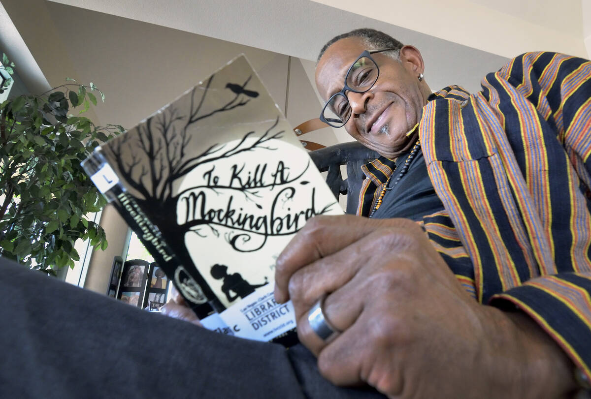 Actor and teacher Antonio Fargas is shown with a copy of Harper Lee's "To Kill a Mockingbird" a ...