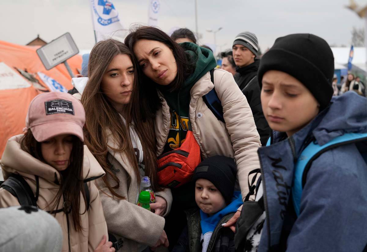 Refugees wait in a queue, after fleeing the war from neighbouring Ukraine at the border crossin ...