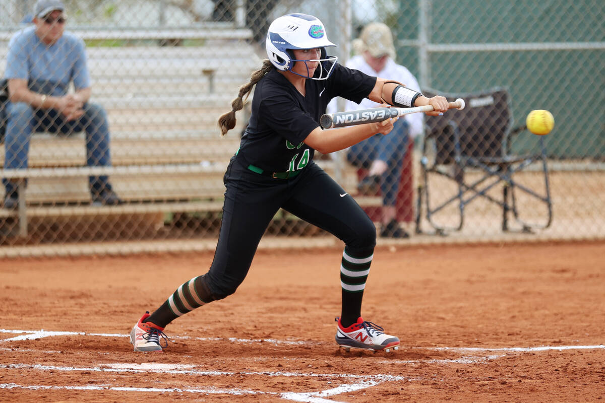 Green Valley’s Rustie Riley (14) attempts a bunt against Faith Lutheran during a softbal ...