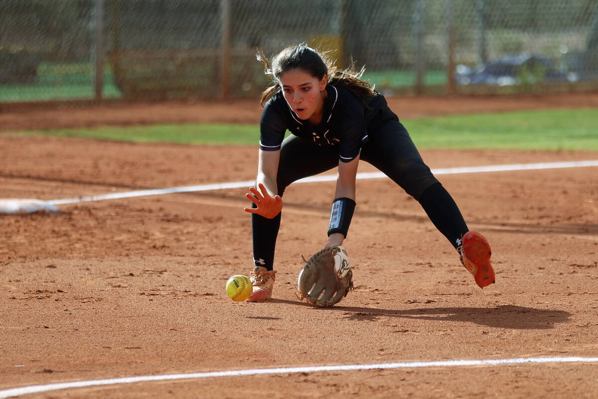 Faith Lutheran’s Shaylee Ghadery (16) catches a ground ball before throwing it to first ...