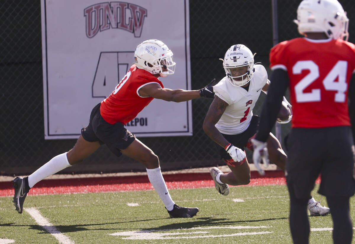 UNLV Rebels wide receiver Kyle Williams (1) runs the ball after a reception under pressure from ...
