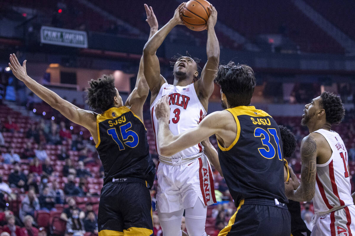 UNLV Rebels forward Donovan Williams (3) looks to shoot between San Jose State Spartans forward ...