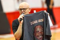 Host Chet Buchanan holds up a shirt featuring former player Robert Smith during an open UNLV ba ...