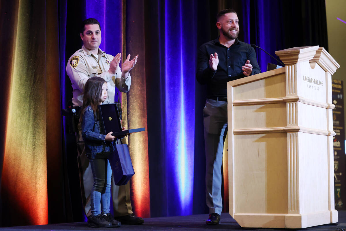 Las Vegas police Capt. Dori Karen, from left, with Evelyn Sanchez, 8, and Detective Cameron Sim ...
