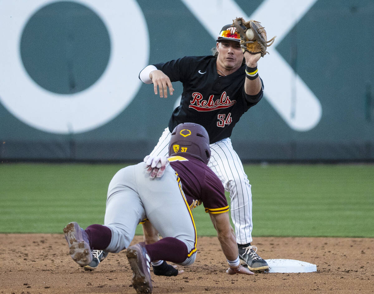 Arizona St. infielder Alex Champagne (37) is tagged out by UNLV infielder Braden Murphy (34) at ...