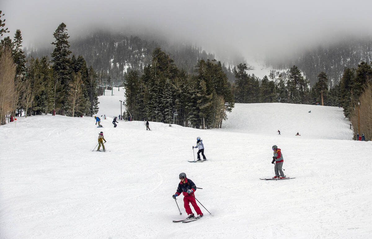 Skiers and snowboarders navigate down a run at Lee Canyon on the final week of the ski season o ...