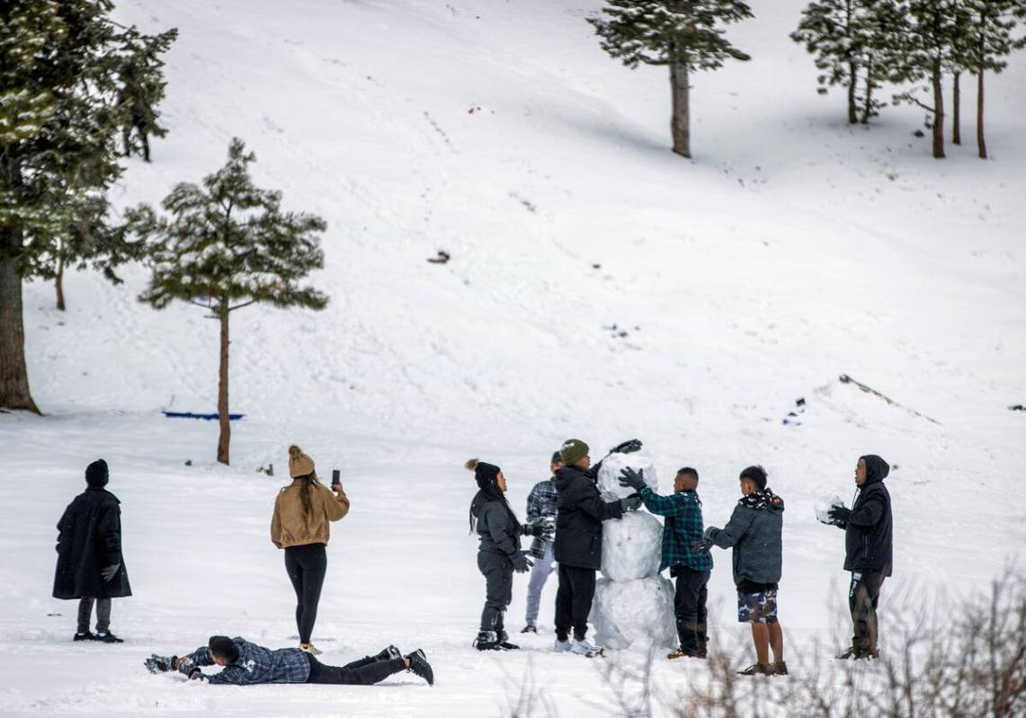 A group of friends complete a snowman at Lee Canyon on the final week of the ski season on Tues ...