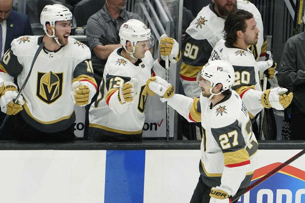 Vegas Golden Knights defenseman Shea Theodore (27) greets teammates after he scored a goal agai ...