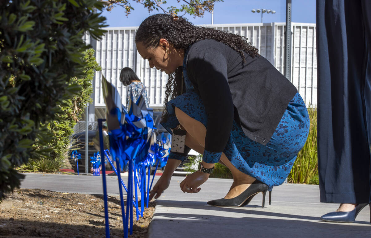 Abbie Frierson, assistant director of Clark County Family Services plants pinwheels within the ...
