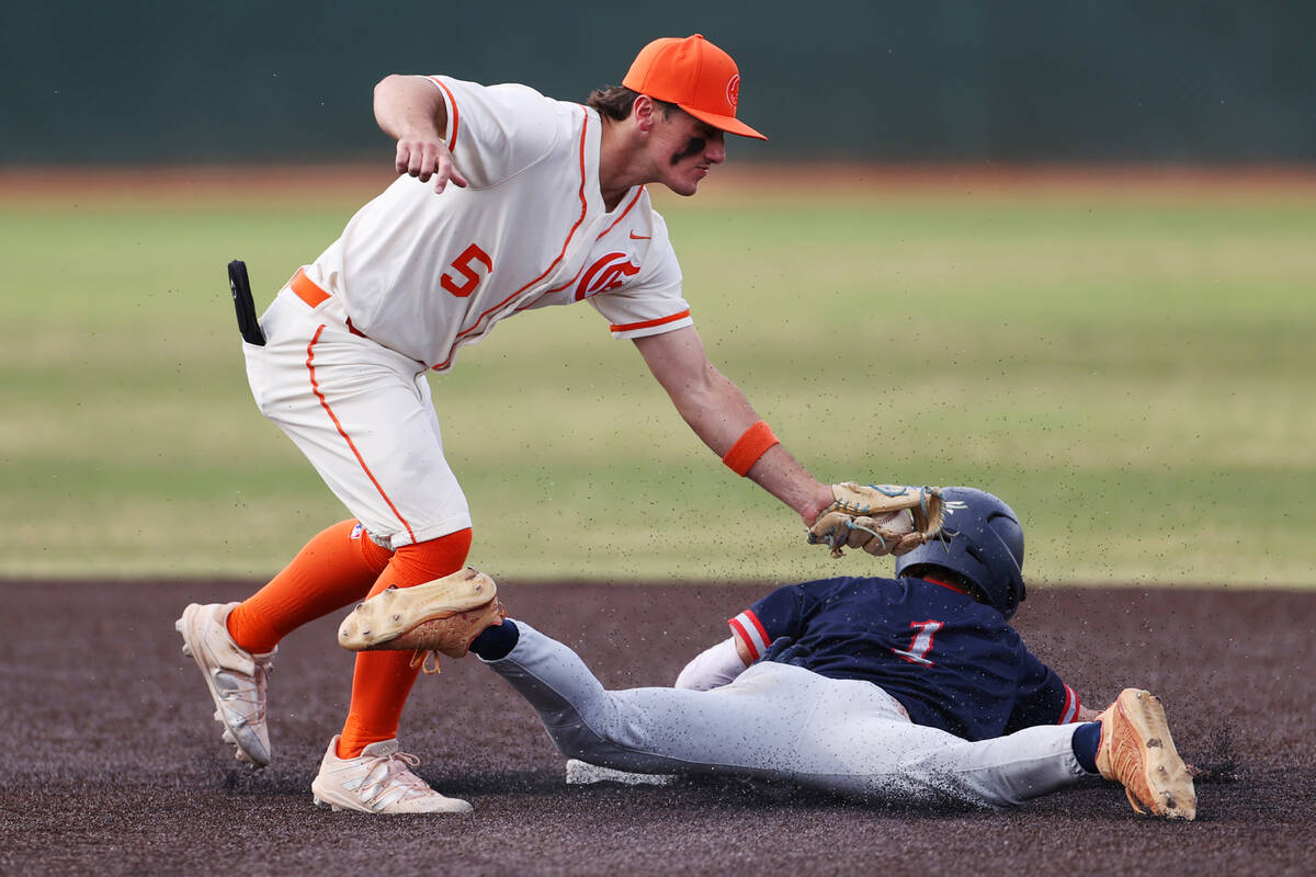 Liberty’s Logan Meusy (1) is tagged out at second base by Bishop Gorman’s Demitri ...