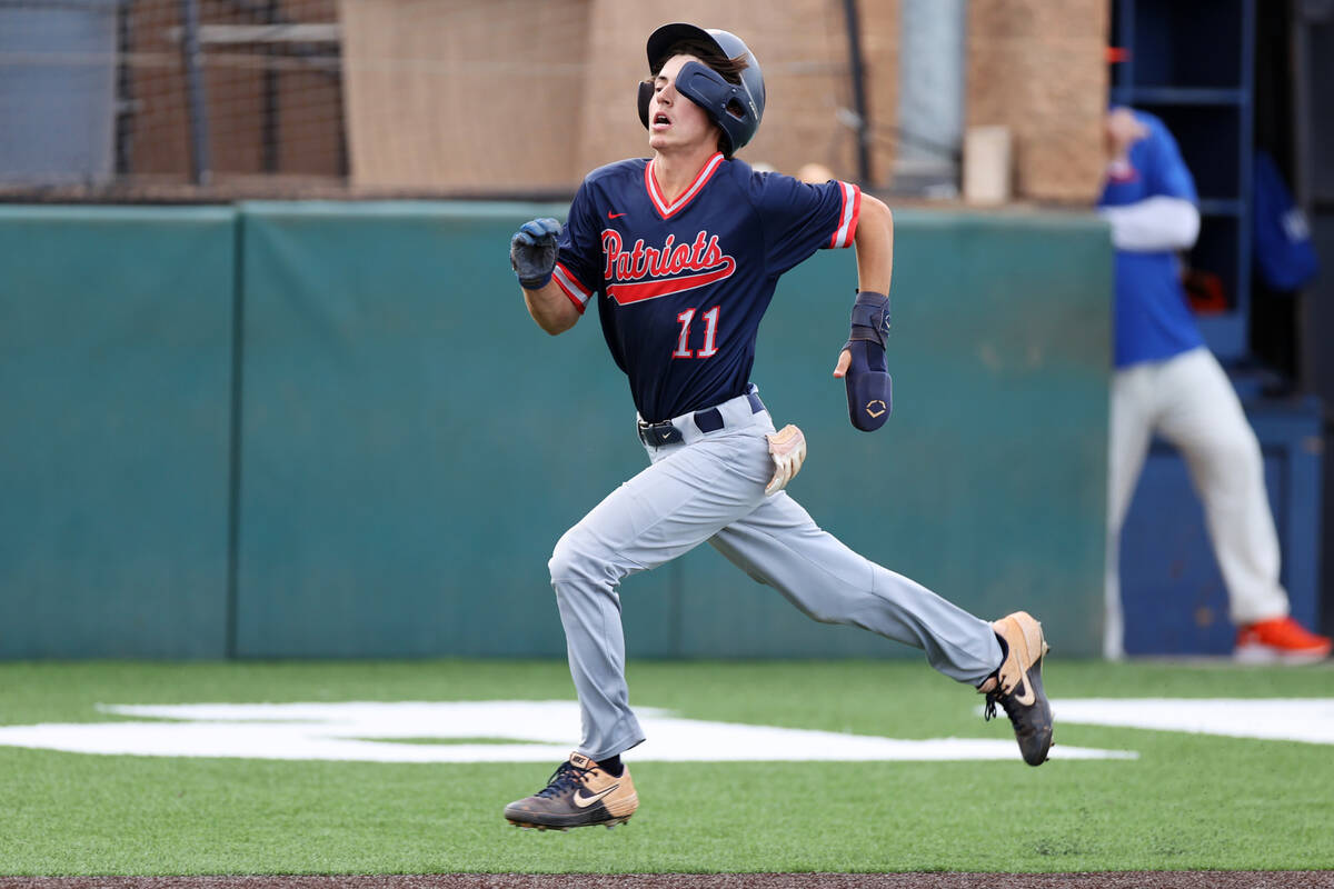 Liberty’s Dylan Fisher (11) runs home for a run against Bishop Gorman during a baseball ...