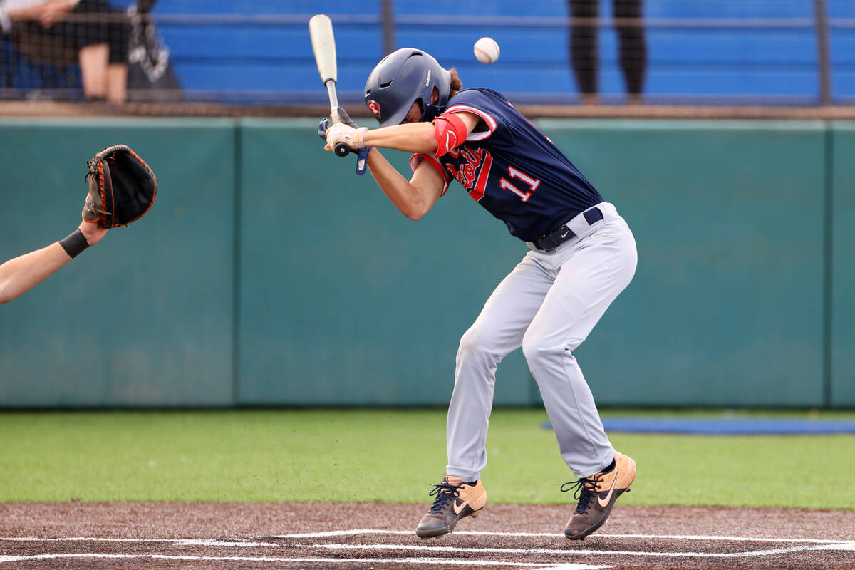Liberty’s Dylan Fisher (11) is hit by a pitch during a baseball game against Bishop Gorm ...