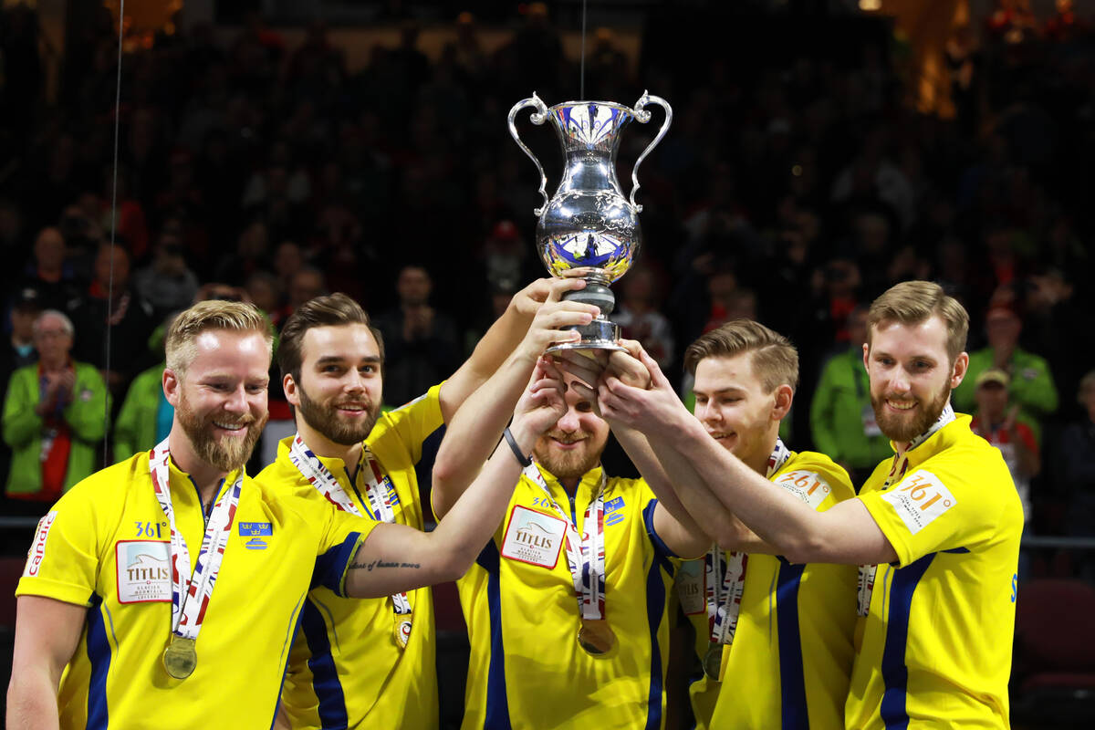 Team Sweden hoists its trophy after defeating Canada in the World Men's Curling Championship at ...