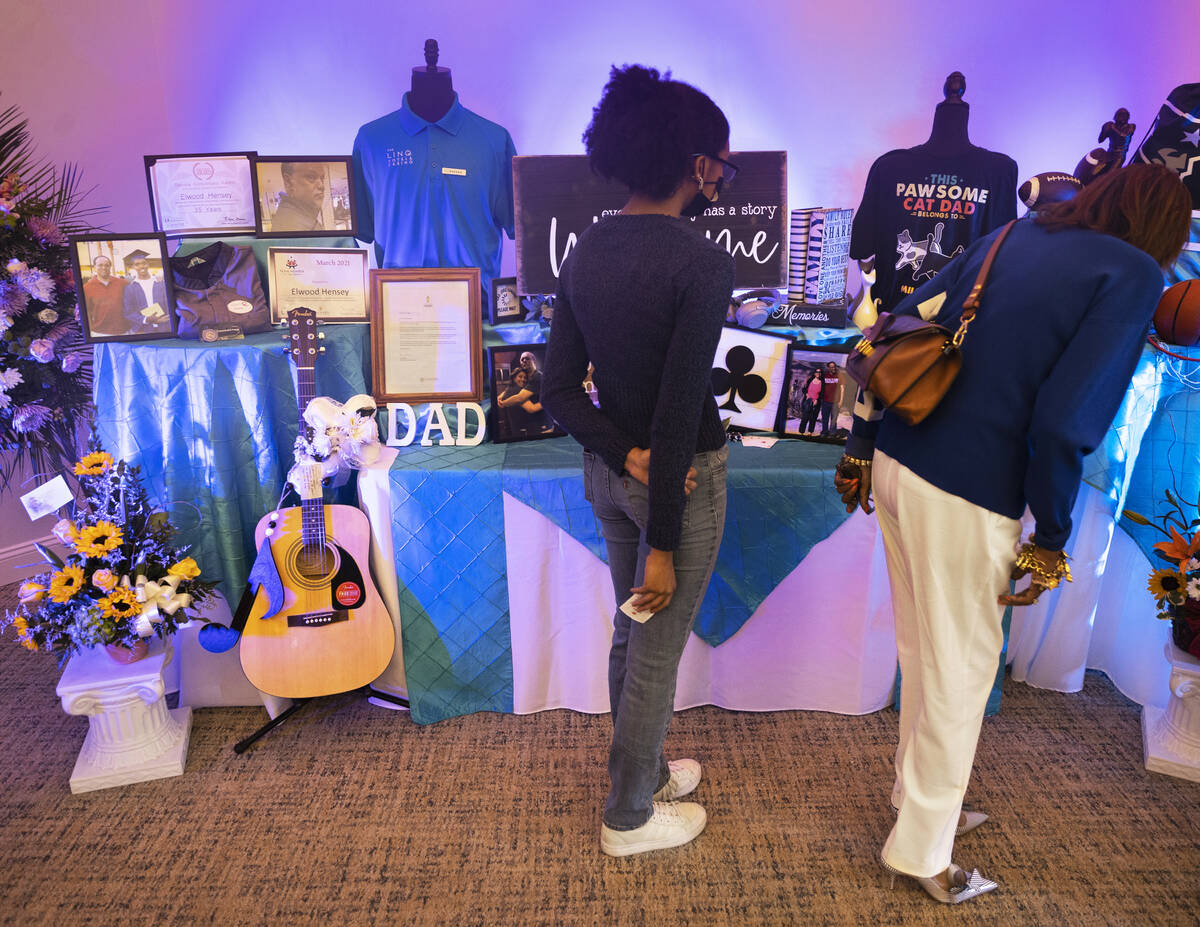 Friends and family visit a wall commemorating Elwood Hensey, 60, during a funeral service for t ...