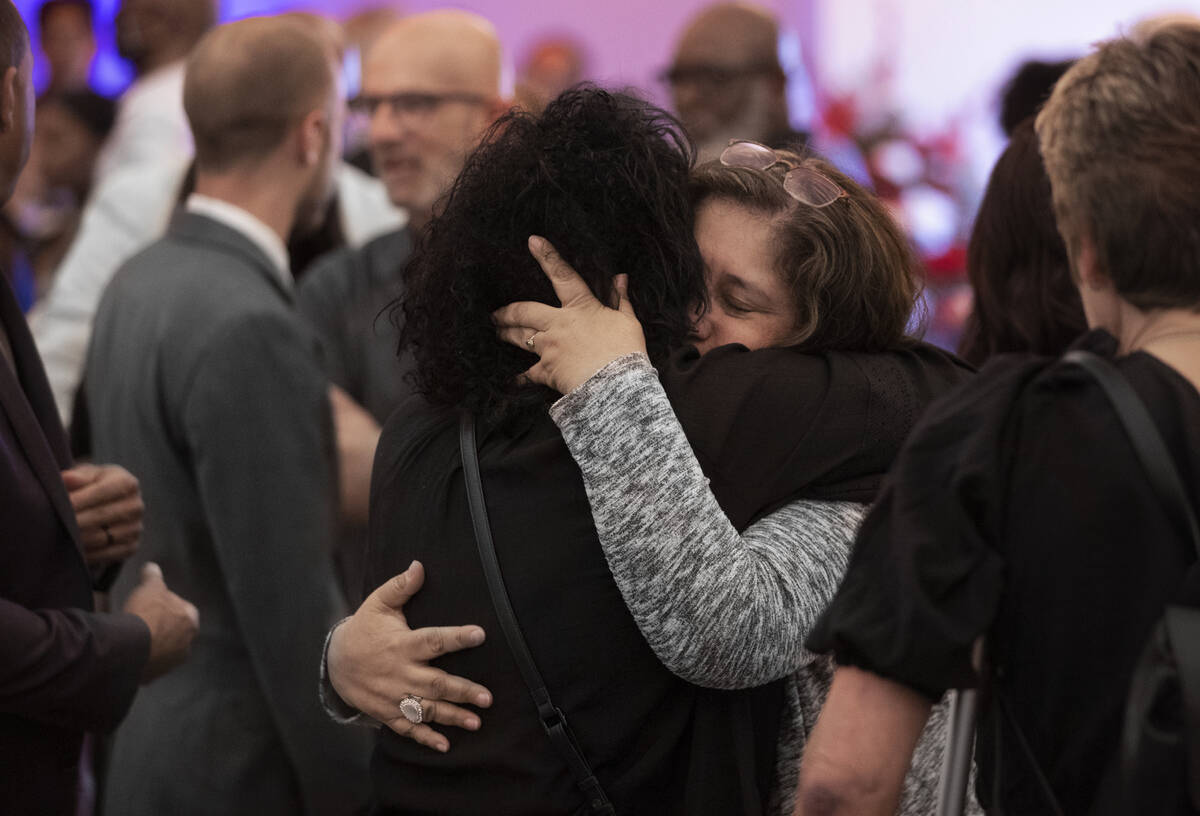 Alicia Jimenez, life partner of Elwood Hensey, is consoled by friends and family during a funer ...