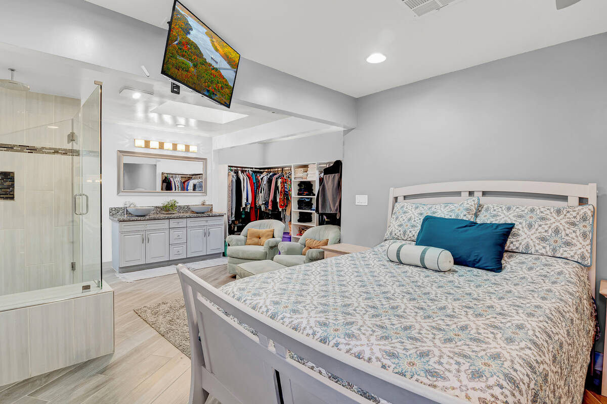 The primary bedroom with an open-floor bathroom inside a home at 1116 Webb Ave., North Las Vega ...