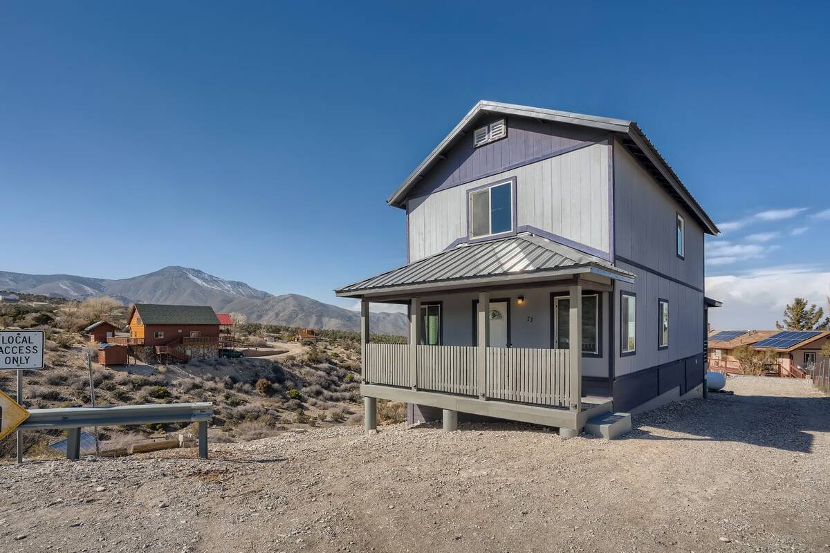 The front exterior of a house at 73 Pinon Road, Cold Creek, Nevada. It's a home for sale at or ...
