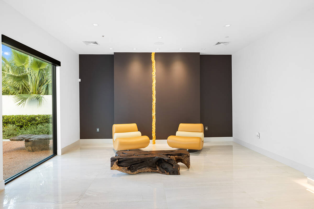 Rupture, a sizeable integrated art piece, depicts a central gold vein dividing the primary blac ...