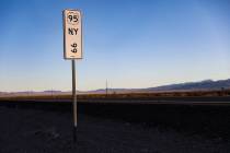 A sign for mile marker 99 near the location of a car crash north of Beatty that killed Georgia ...